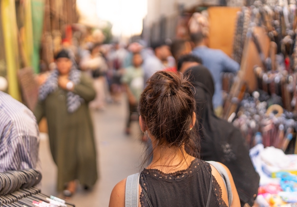 Woman,Walking,Along,A,Street,Market,In,Egypt